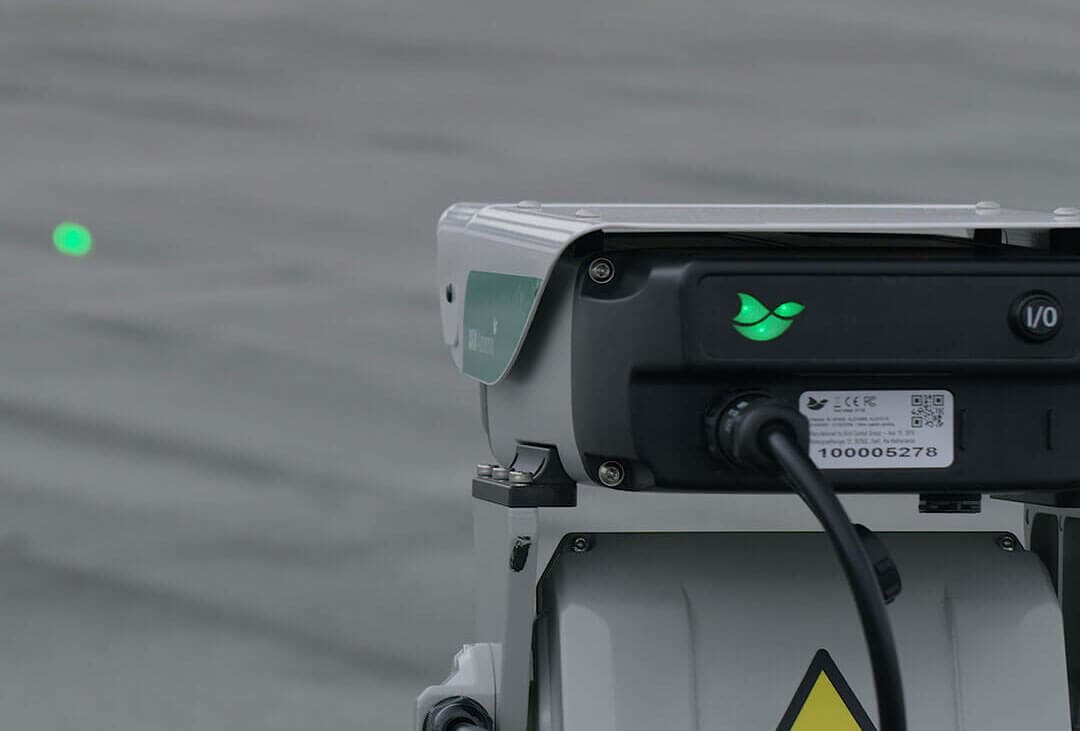 An AVIX laser sweeping a green beam across a site to deter birds